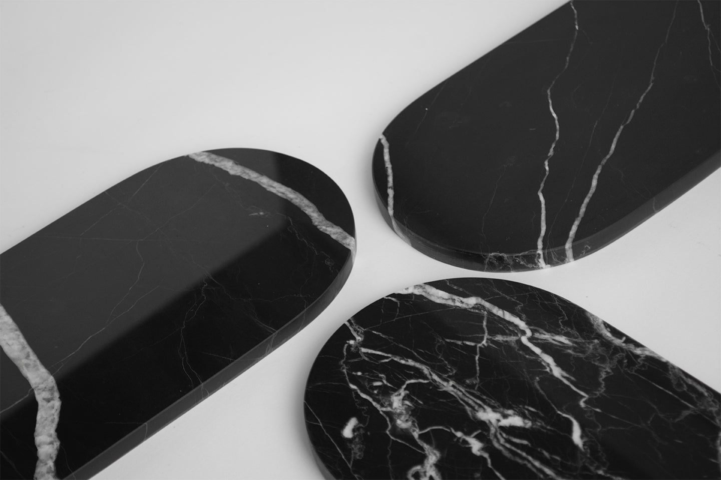 Black marble platter with arched edge on table