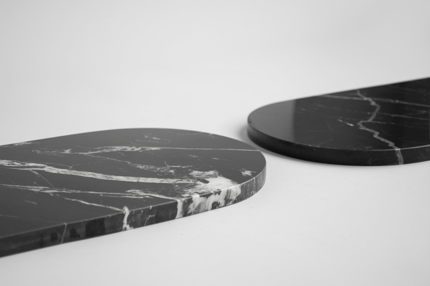 Black marble platter with arched edge on table