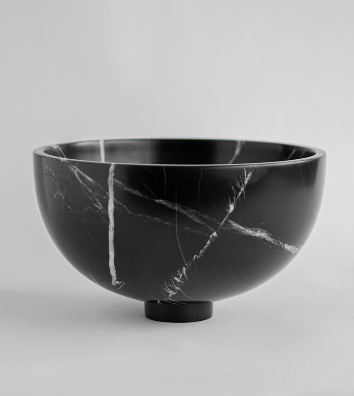 Black marble fruit bowl with pedestal and white veining
