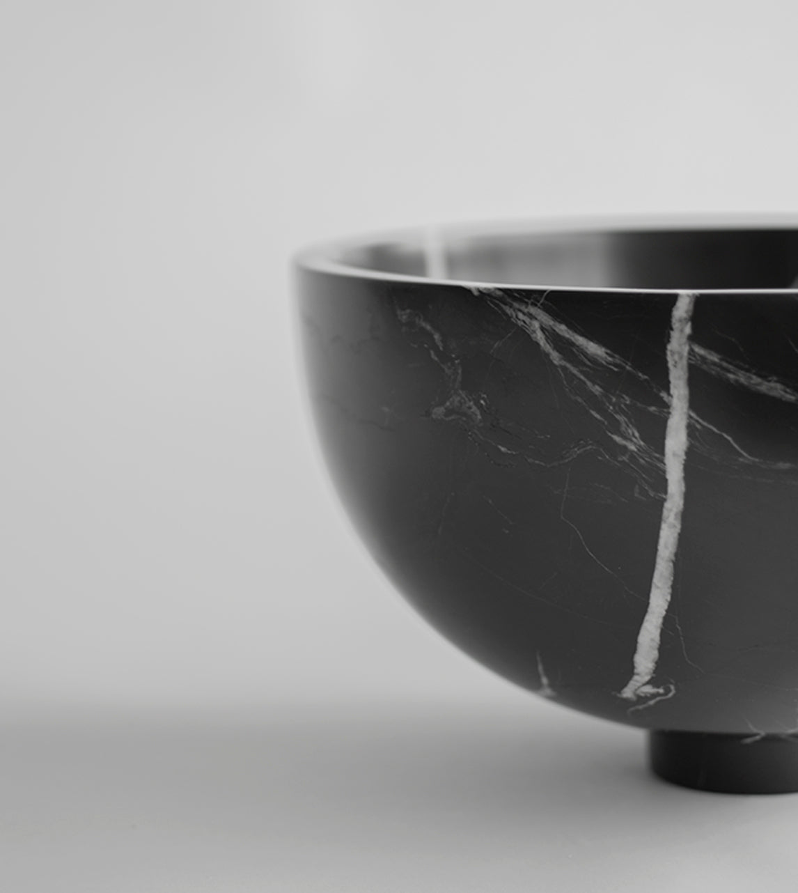 Black marble fruit bowl with pedestal and white veining