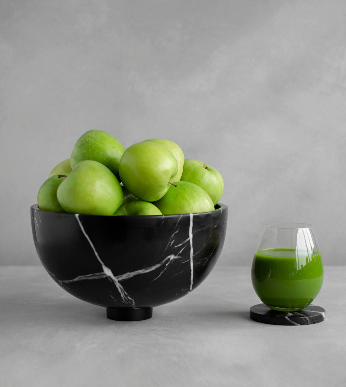 Black marble fruit bowl with pedestal and white veining