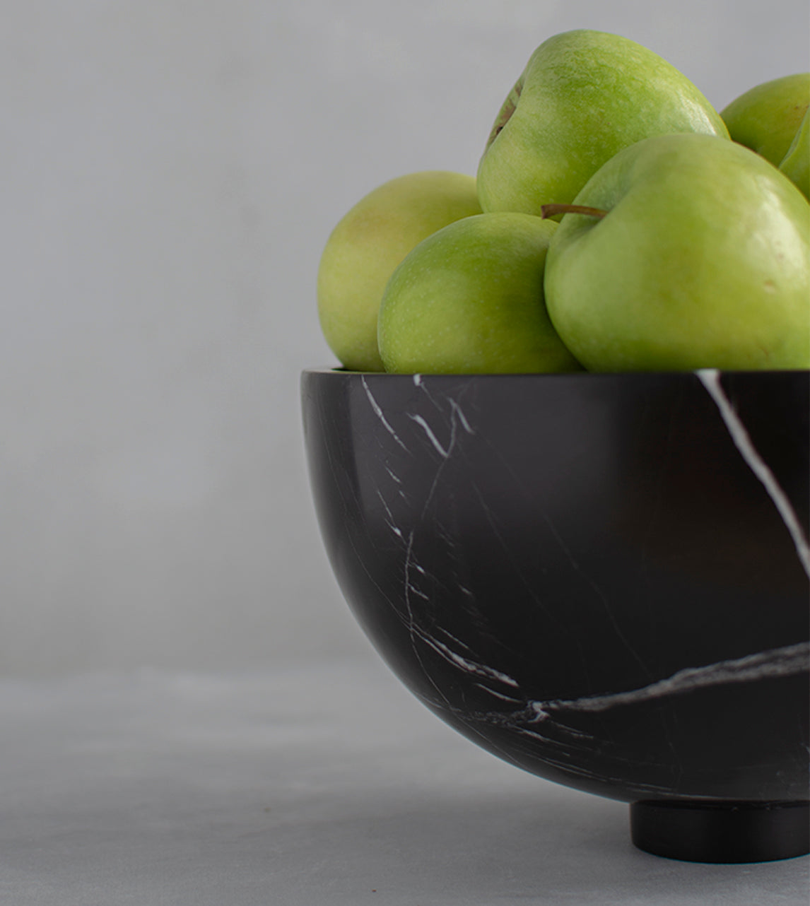 Black marble fruit bowl with pedestal and white veining