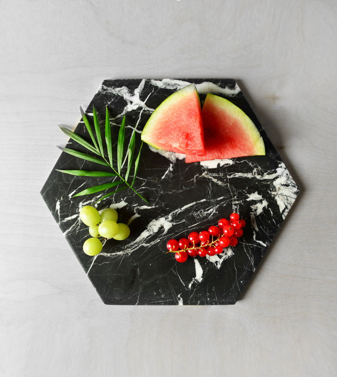 Black marble platter with hexagon shape for serving cheese
