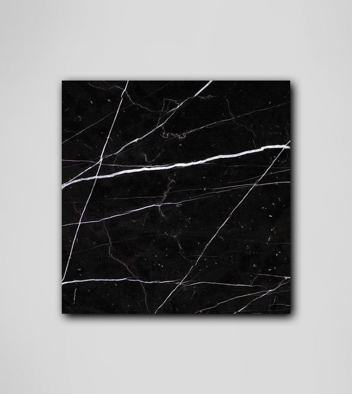 Black marble platter with white veining and square shape