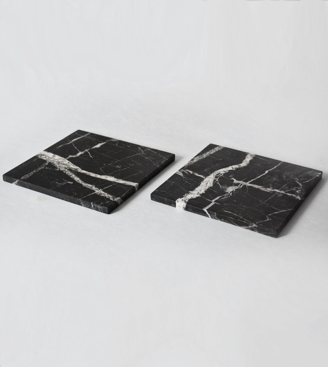 Black marble platter with white veining and square shape
