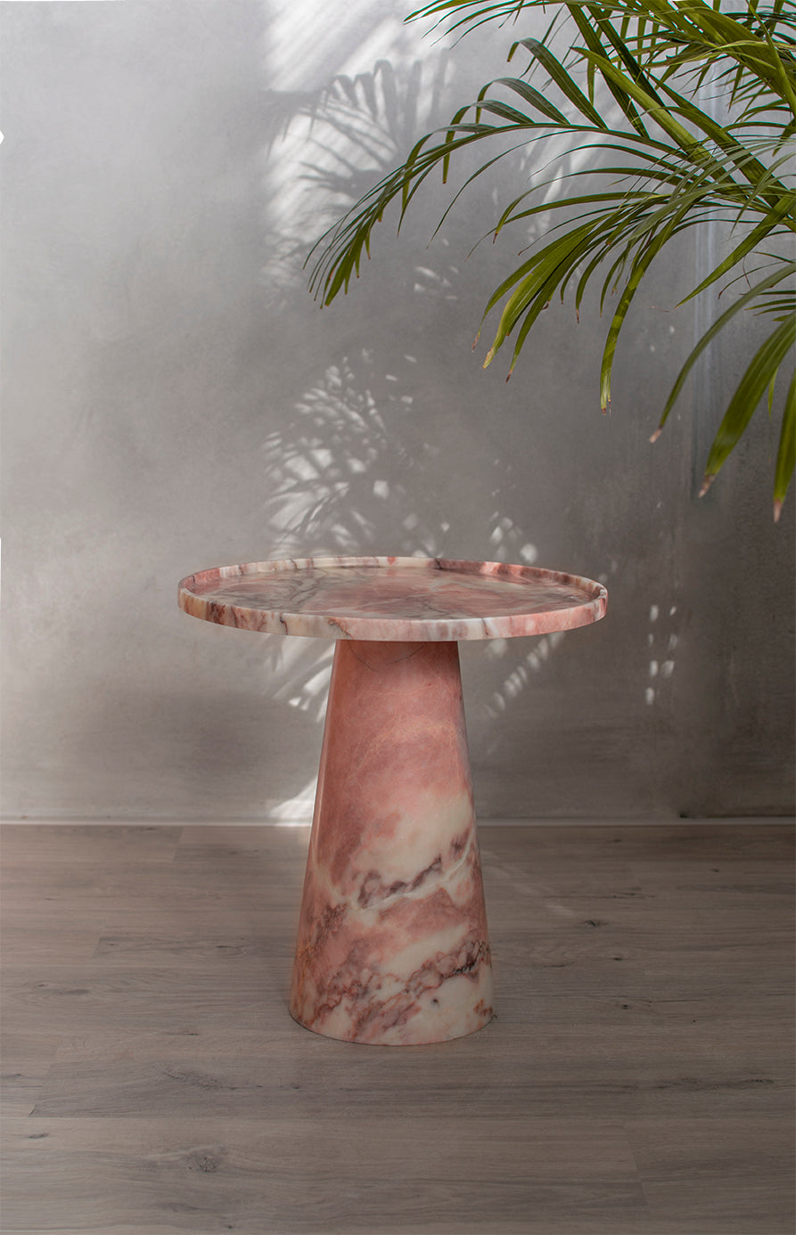 Pink marble cone side table with soft veining and round top