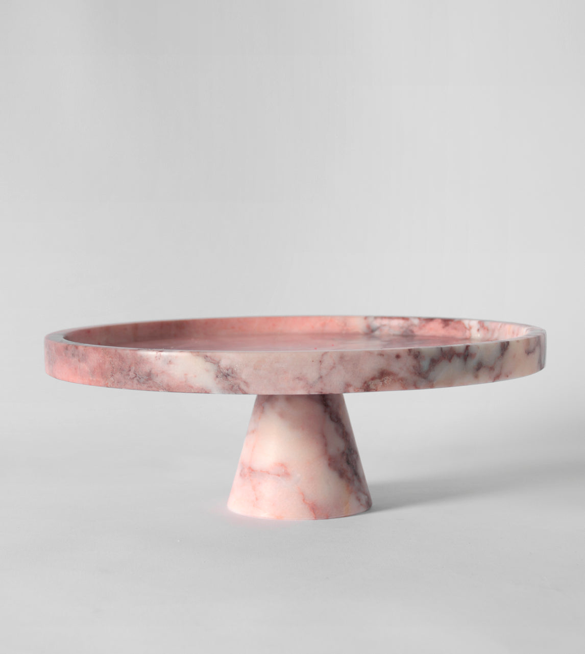 Pink marble pedestal cake stand with elegant design