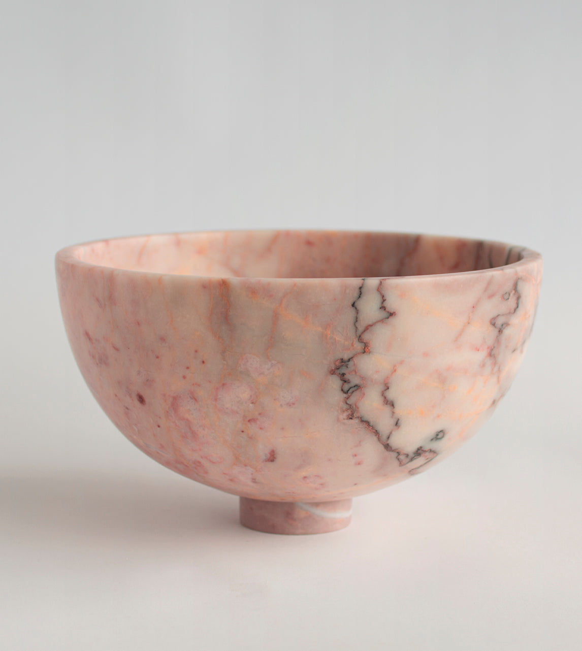 Pink marble fruit bowl with pedestal and natural veining