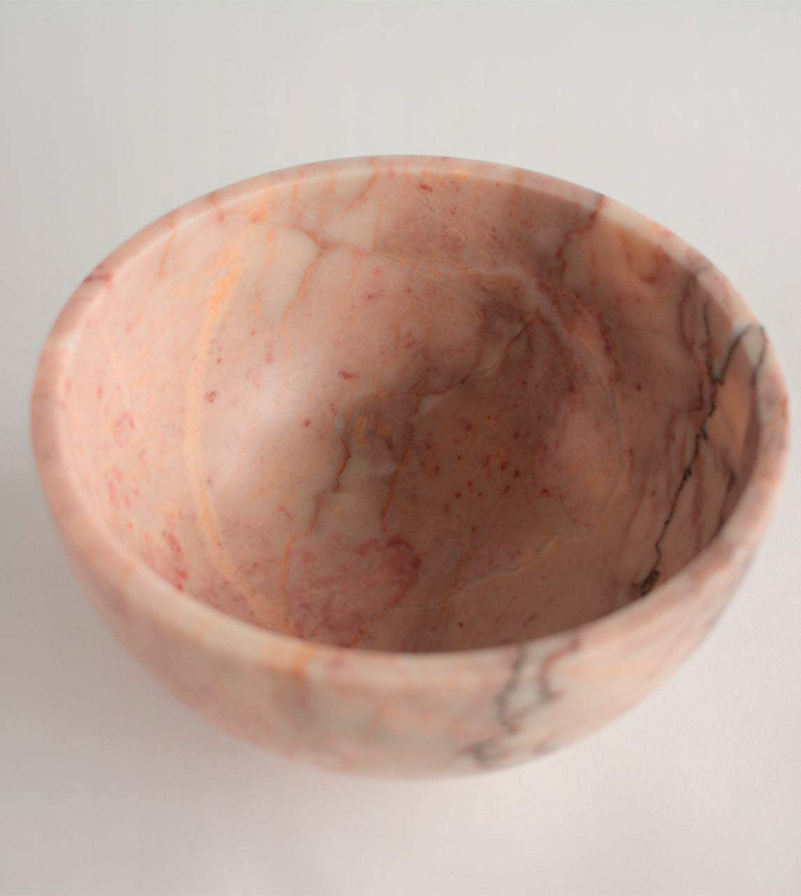Pink marble fruit bowl with pedestal and natural veining