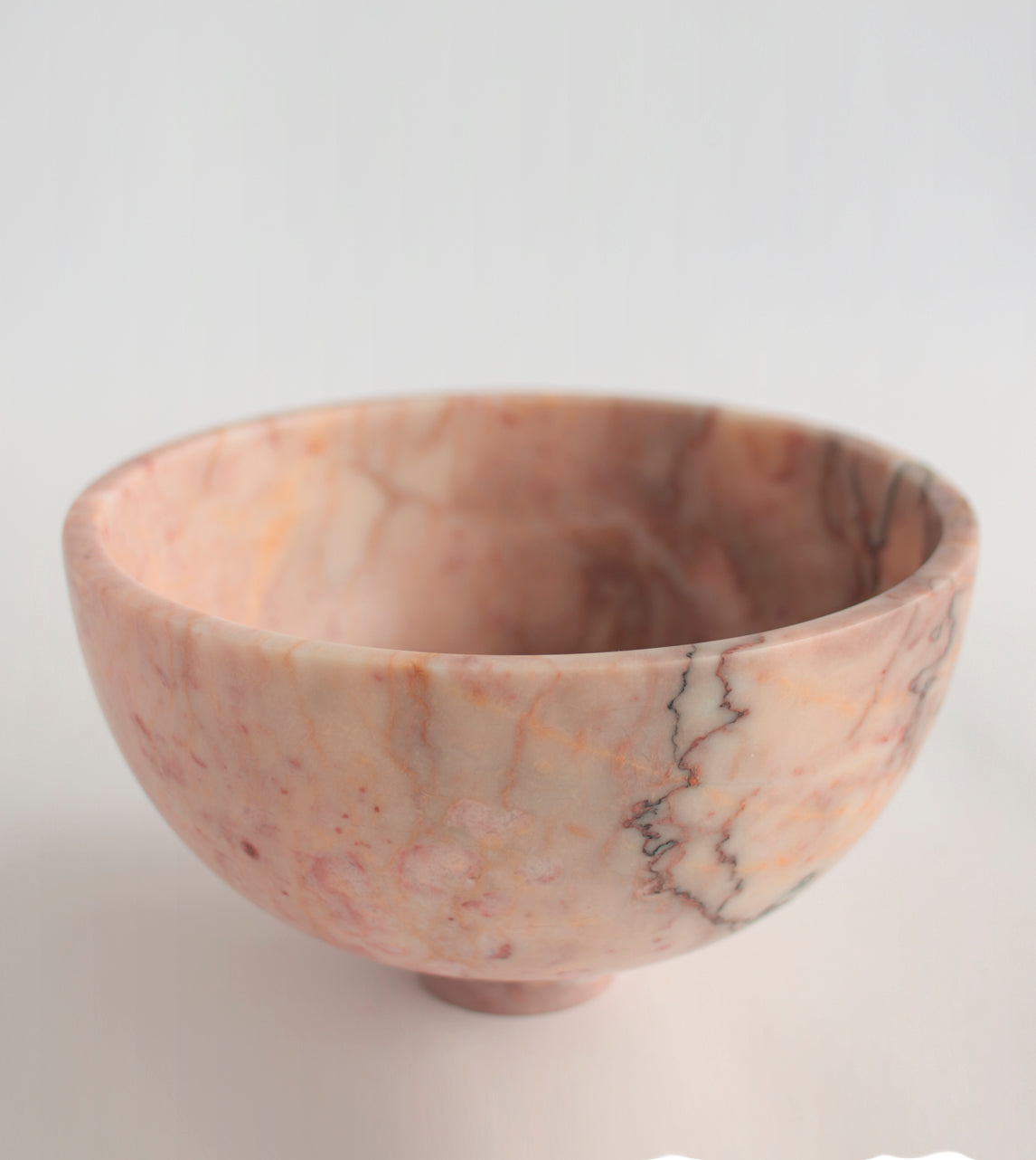 Pink marble fruit bowl with pedestal and natural veining