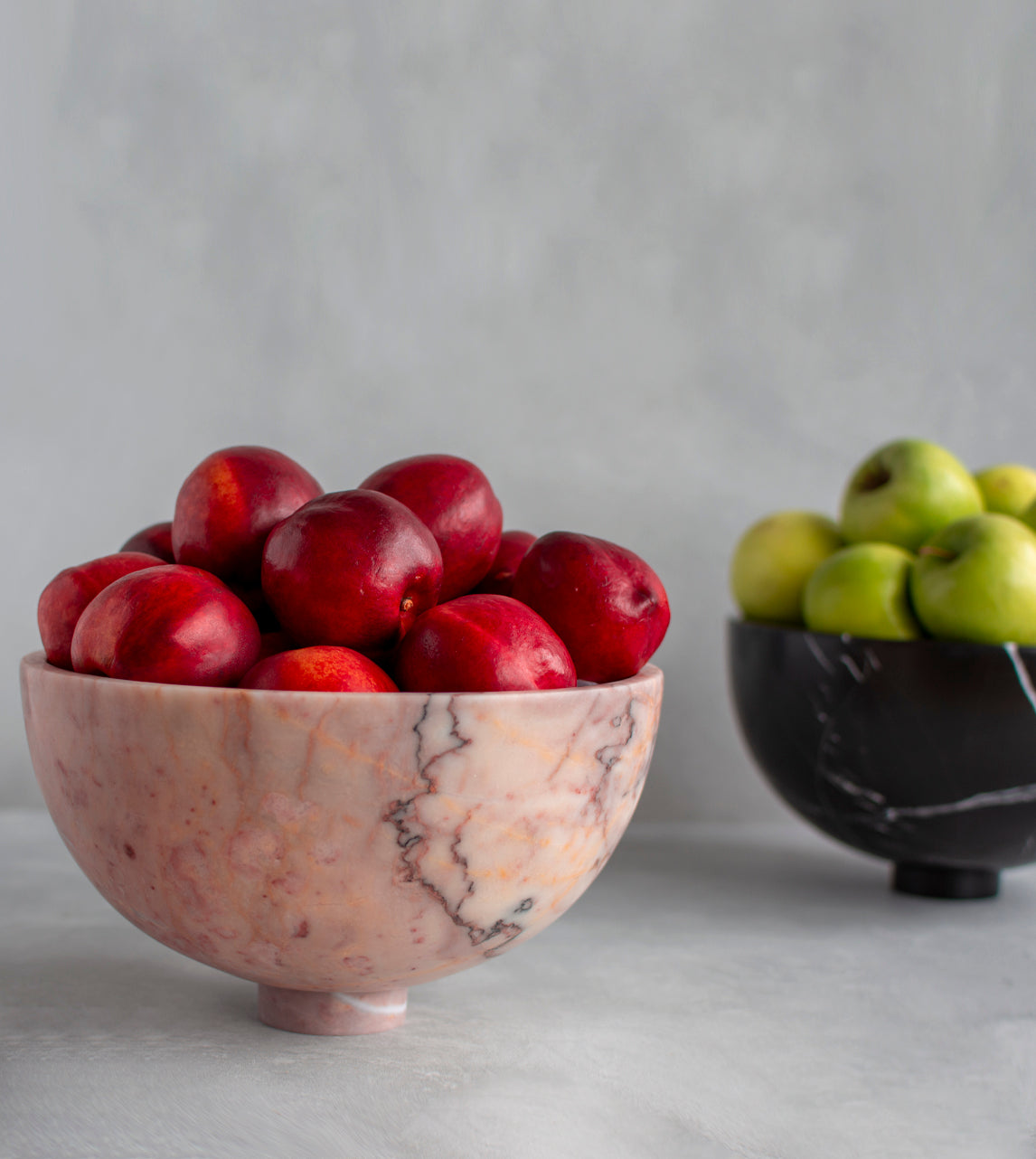 Pink marble fruit bowl with pedestal and natural veining