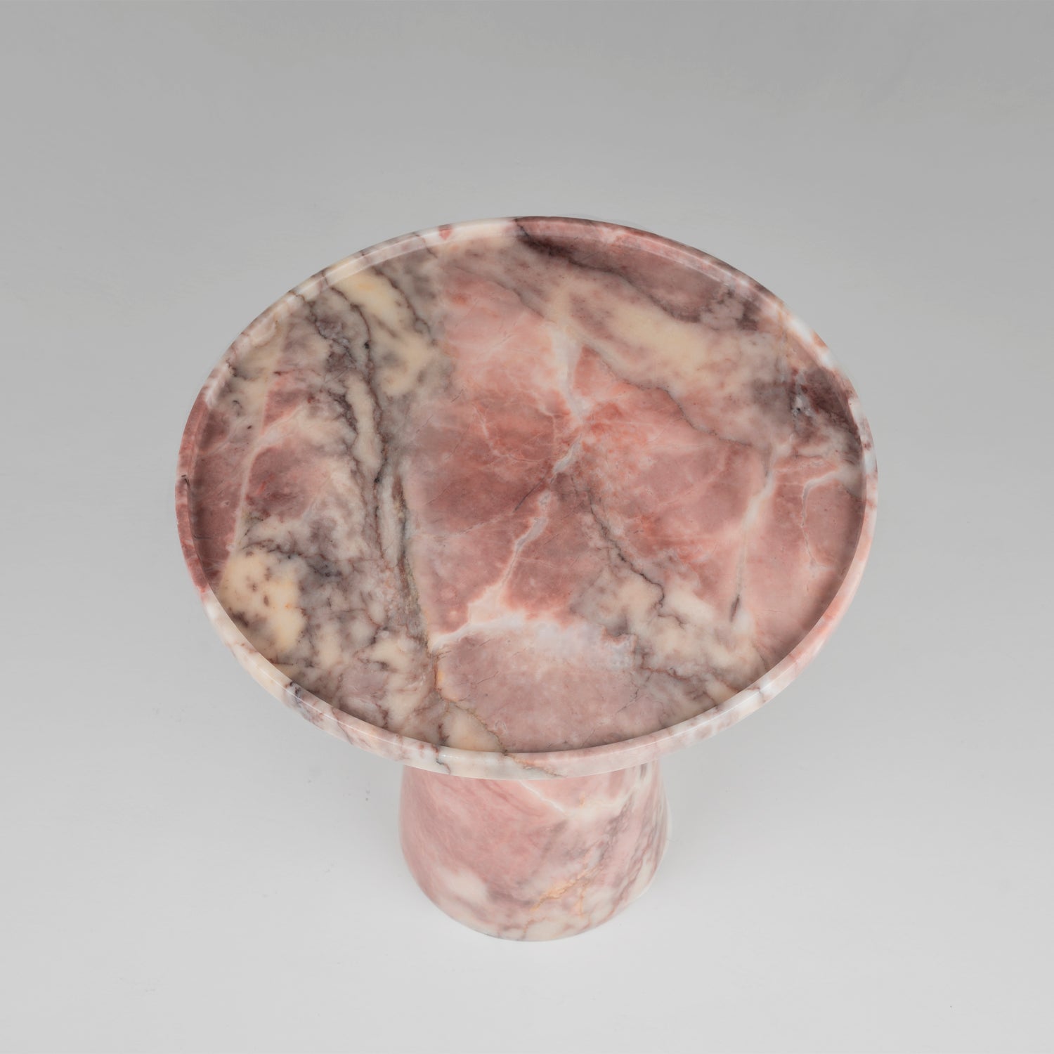 Pink marble cone side table with soft veining and round top