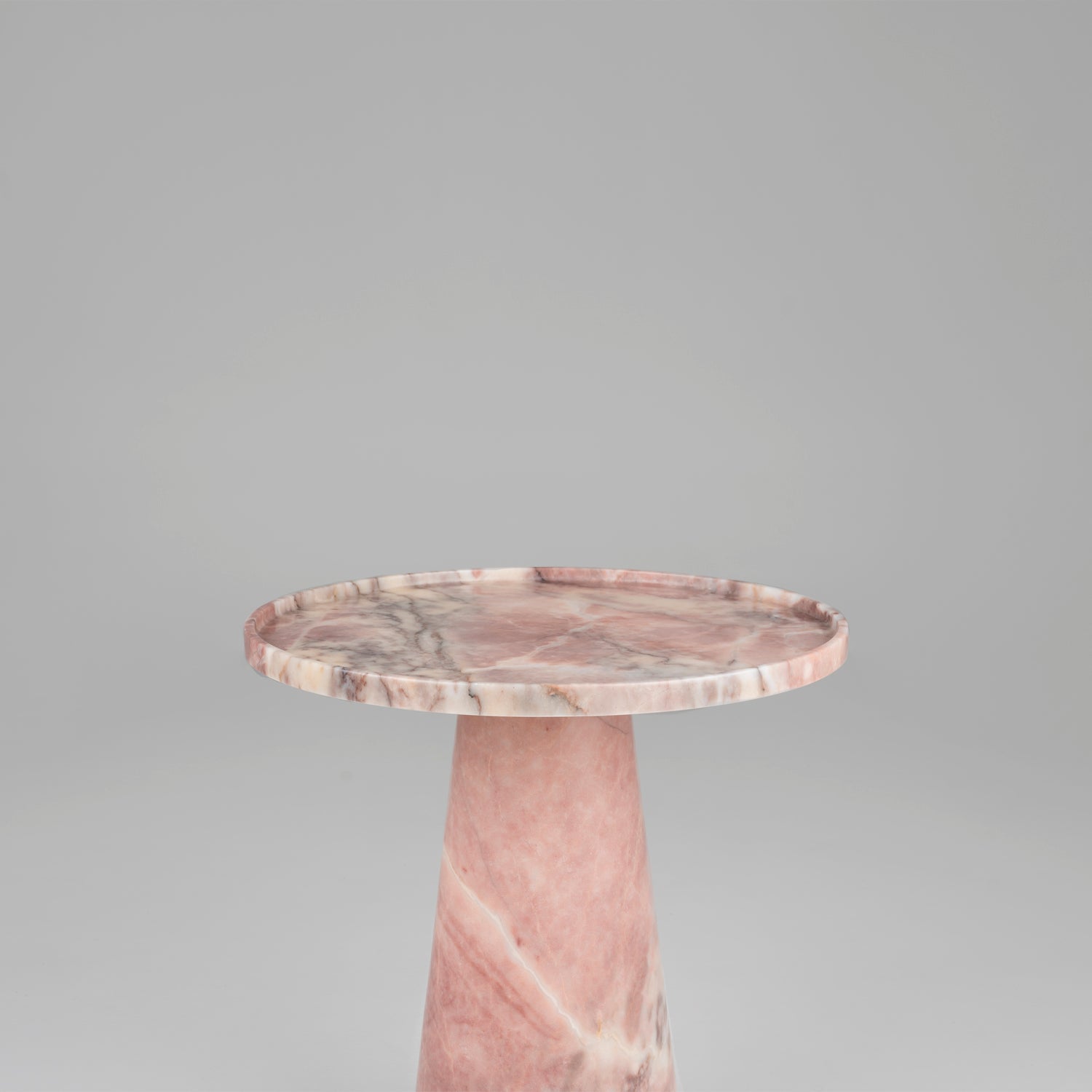 Pink marble cone side table with soft veining and round top