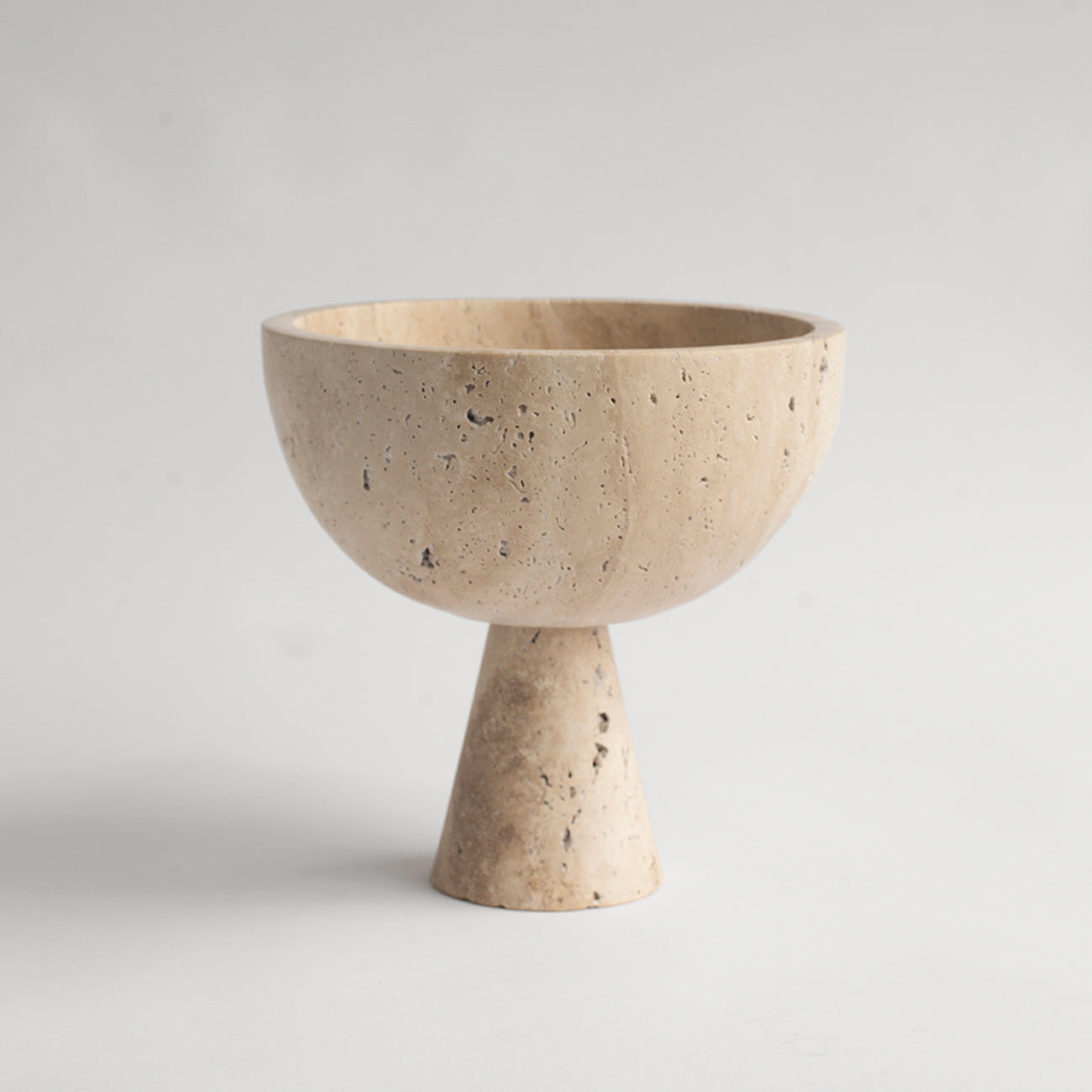 Travertine pedestal bowl with natural stone texture