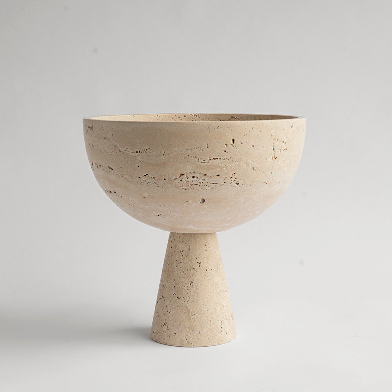 Travertine pedestal bowl with natural stone texture