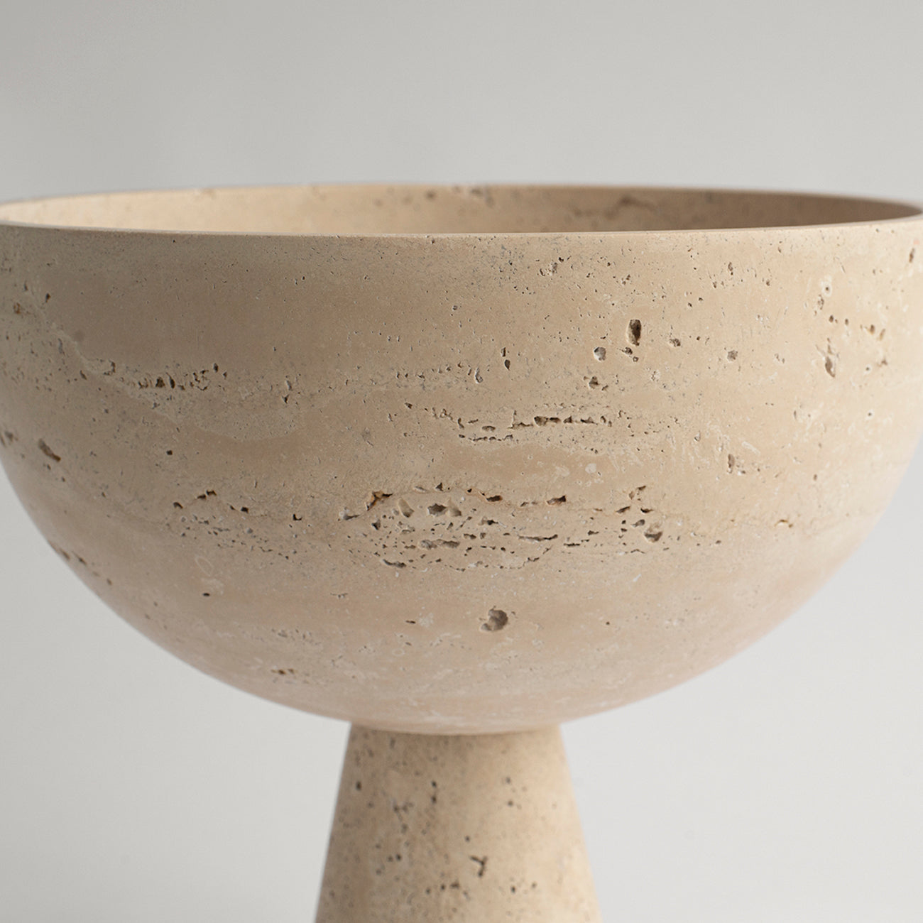 Travertine pedestal bowl with natural stone texture