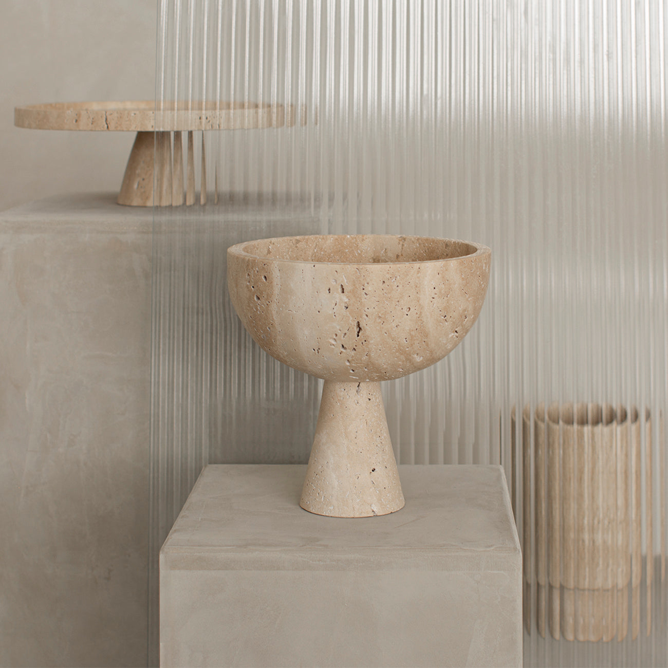 Travertine pedestal bowl with natural stone texture