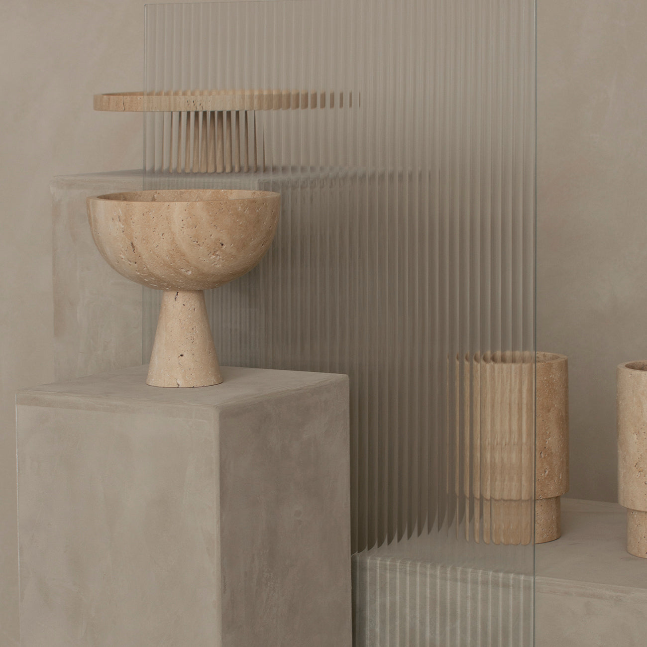 Travertine pedestal bowl with natural stone texture